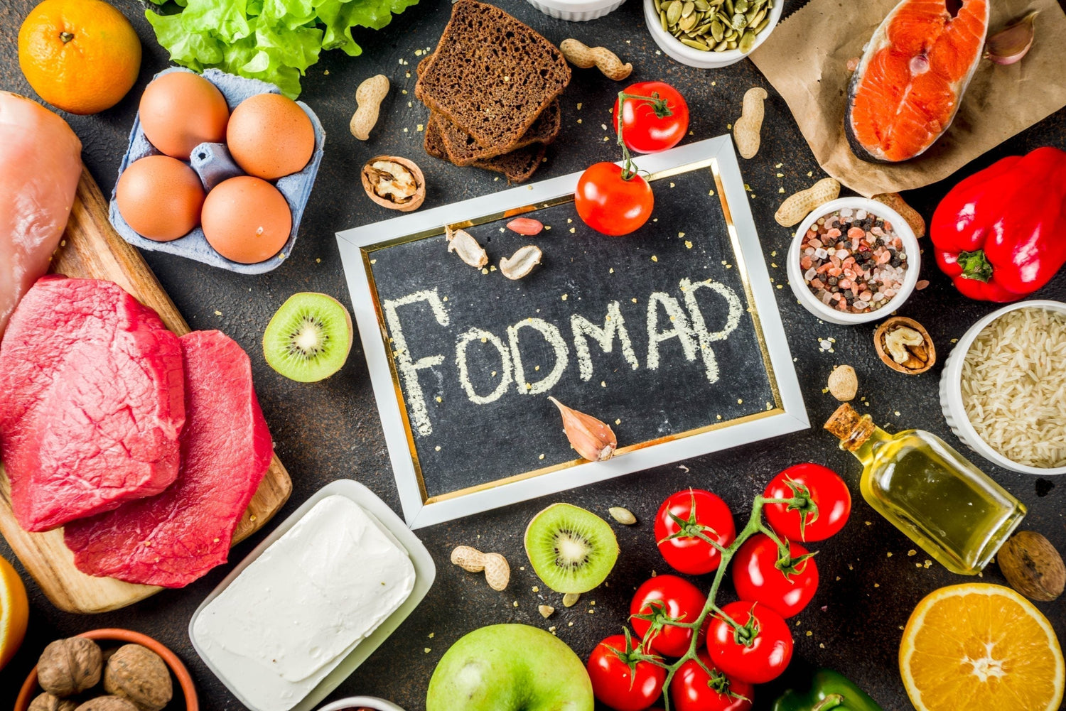 Divers aliments sains autour d'un tableau noir avec le mot FODMAP illustrant la méthode Low FODMAP
